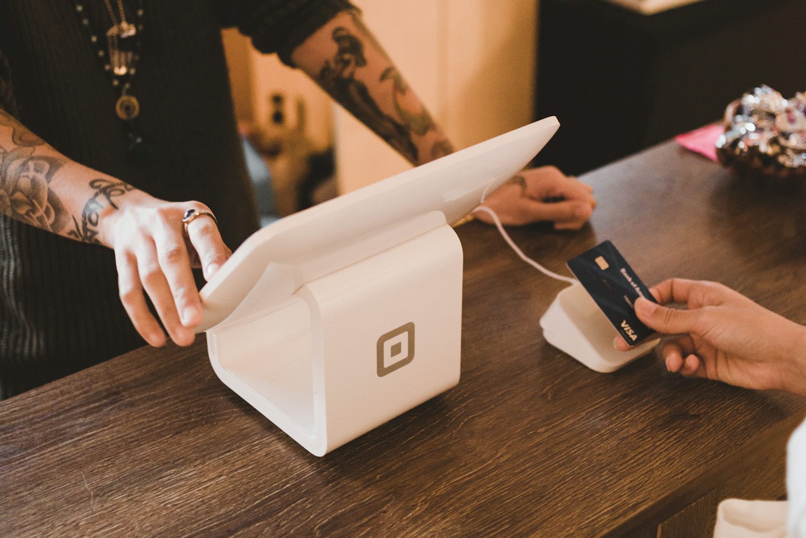 A customer paying by card at a checkout counter